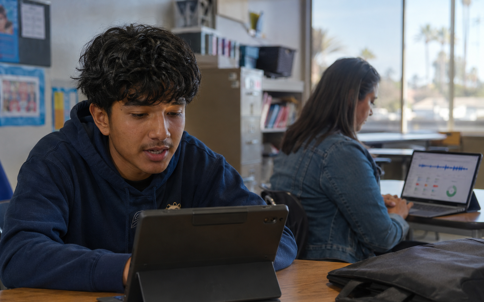 San Diego Unified student and teacher reviewing voice-analysis data on tablets